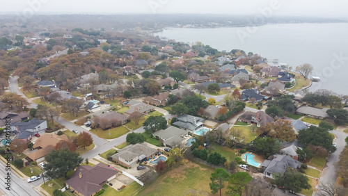 Aerial view residential homes with swimming pool, large backyard, matured trees next to Lake Arlington in Tarrant County, Dallas–Fort Worth metroplex, upscale two-story subdivision houses park photo