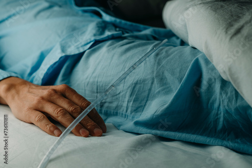 man wearing a urinary catheterization in bed photo
