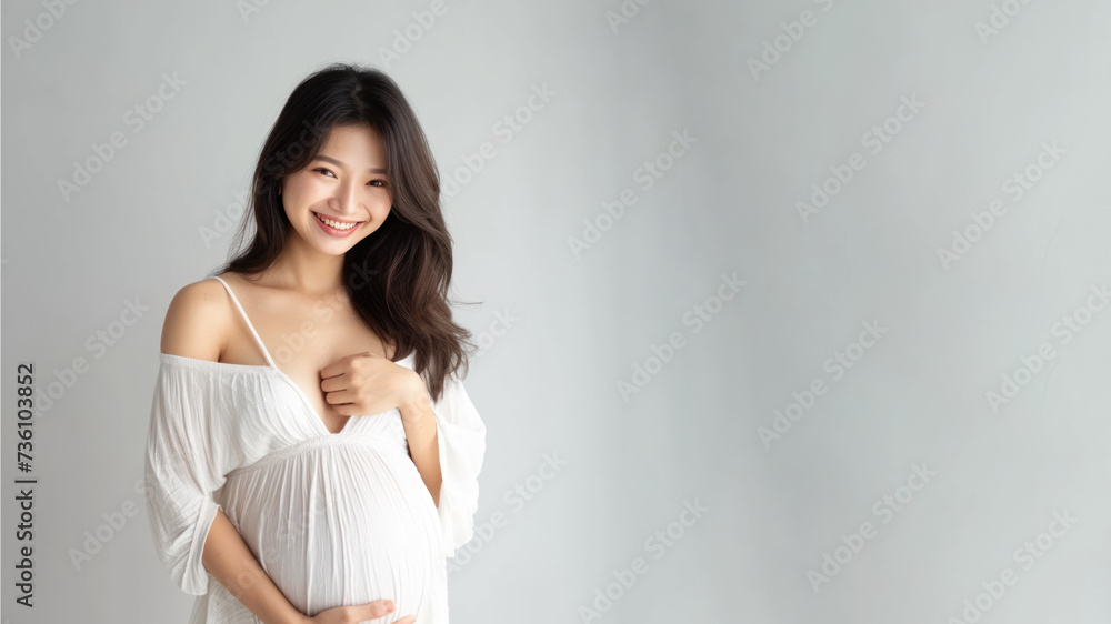 Asian pregnant woman with pregnancy belly, in soft white clothes Asian pregnant woman with pregnancy belly, in soft white clothes