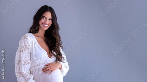 Hispanic pregnant woman with pregnancy belly, in soft white clothes © pariketan