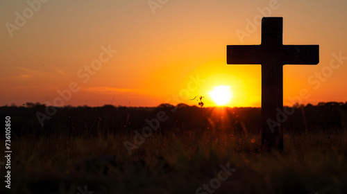 Silhouetted Cross at Sunset in Field
