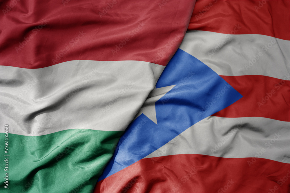 big waving national colorful flag of puerto rico and national flag of hungary . big waving national colorful flag of puerto rico and national flag of hungary .