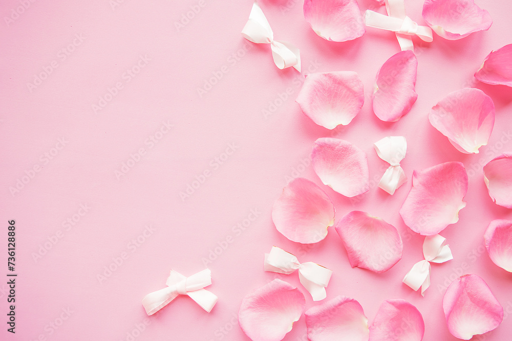 pink rose petals on pink background. Copy space for the text