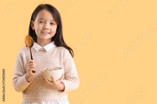 Cute little Asian girl eati...