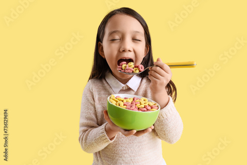 Cute little Asian girl eati...