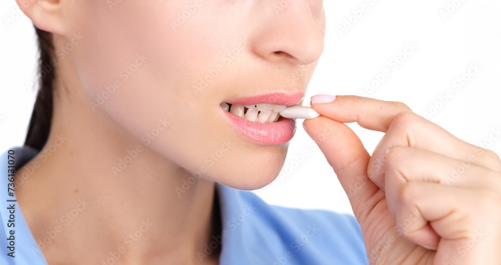 Woman putting chewing gum in her mouth with hand closeup. Protecting against caries after eating concept Woman putting chewing gum in her mouth with hand closeup. Protecting against caries after eating concept