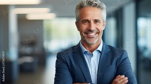 Smiling older bank manager or investor, happy middle aged business man boss ceo, confident mid adult professional businessman executive standing in office.