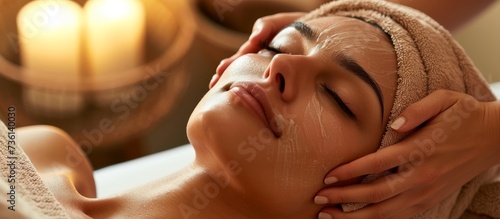 Relaxing facial massage treatment for woman in luxury spa salon with essential oils and soft music
