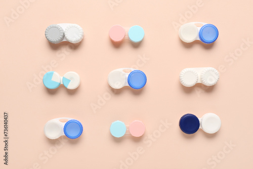 Containers for contact lenses on beige background