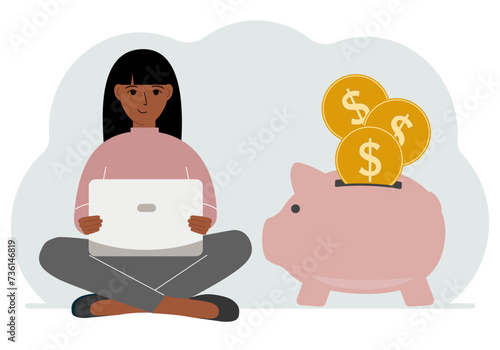 A woman sits cross-legged with a laptop next to a pig piggy bank. Earning money, saving, saving money.