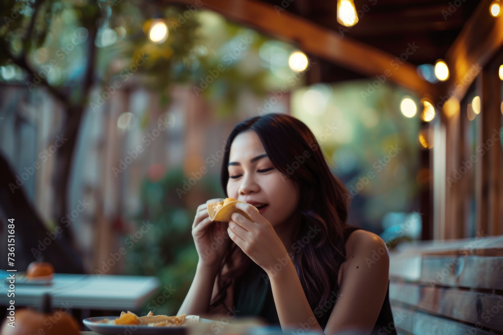 Portrait of young woman eating a delicious taco in restaurant outdoors Portrait of young woman eating a delicious taco in restaurant outdoors