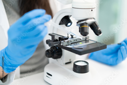 researcher using microscope analyse cell in medical lab.