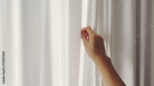 A woman's hand reaching out from behind a white curtain. Can be used to depict curiosity, mystery, or anticipation. Ideal for use in advertising, storytelling, or illustrating a hidden message