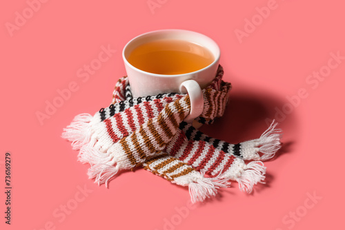 Mug of tea with warm scarves. Spring bad weather.