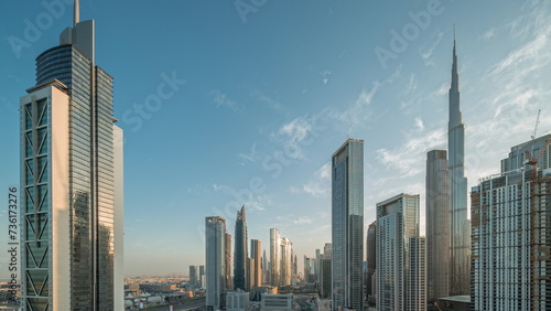 Aerial sunrise view of Dubai Downtown skyline with many towers night to day timelapse. photo