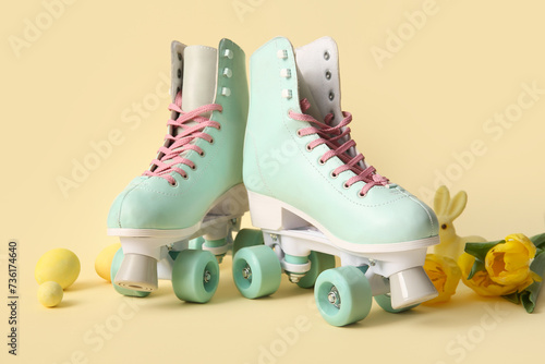 Vintage roller skates with Easter eggs and beautiful tulips on yellow background