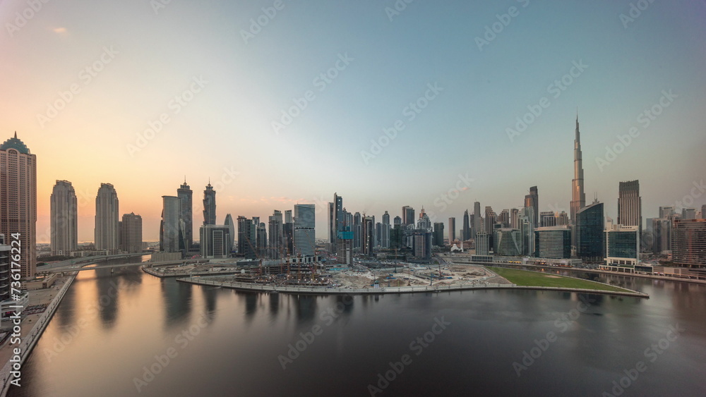 Cityscape with skyscrapers of Dubai Business Bay and water canal aerial timelapse.