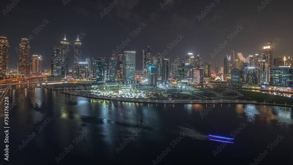 Panorama showing aerial view to Dubai Business Bay and Downtown with the various skyscrapers and towers night timelapse