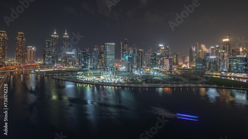 Panorama showing aerial view to Dubai Business Bay and Downtown with the various skyscrapers and towers night timelapse