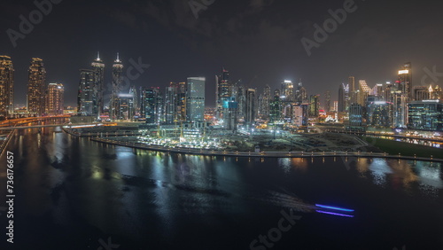 Panorama showing aerial view to Dubai Business Bay and Downtown with the various skyscrapers and towers night timelapse © neiezhmakov