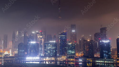 Aerial view to Dubai Business Bay and Downtown with the various skyscrapers and towers all night timelapse