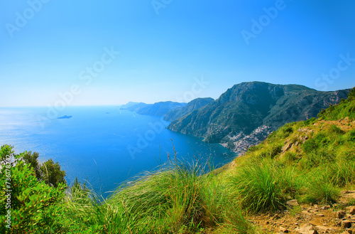 Amalfi Coast, Positano, Peninsula of Sorrento, Campania, Italy. View from Path of the Gods, Sentiero degli Dei. Town Positano on the right. Island Capri in the background.