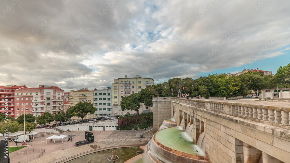 Panorama showing aerial view of Jardim da Alameda in Lisbon with the Luminous Fountain timelapse during sunset.
