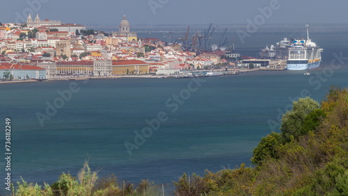 Aerial view of Lisbon over Tagus river from viewpoint of Cristo Rei in Almada with yachts tourist boats timelapse. Lisbon, Portugal photo