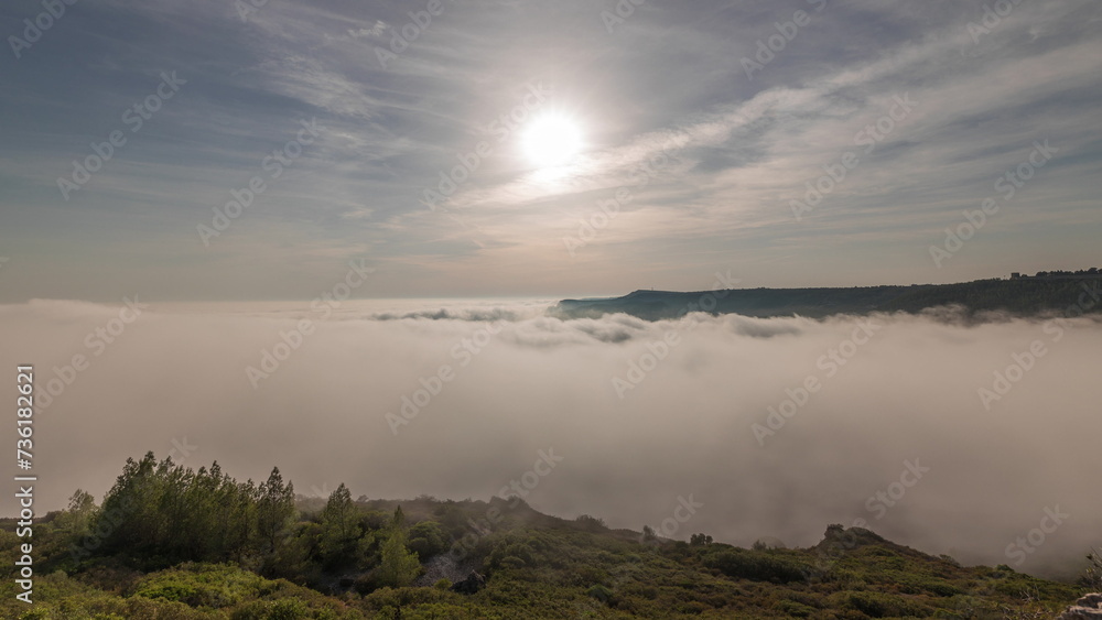 Panorama showing aerial View of Sesimbra Town and Port covered by fog timelapse, Portugal.