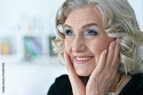 Beautiful happy senior woman posing at home