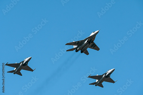 Military air force fighter jet interceptor airplane in full flight against the blue sky