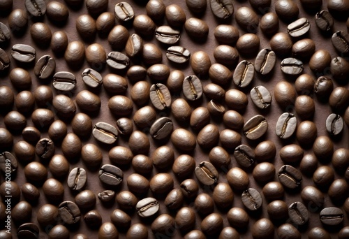 Coffee beans scattered on a brown textured surfac photo