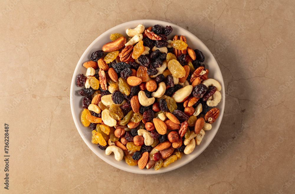 Mix of dried nuts and raisins on a stone background. Mix of dried nuts and raisins on a stone background.