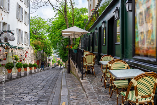 Cozy street with tables of cafe in quarter Montmartre in Paris, France. Cozy cityscape of Paris. Architecture and landmarks of Paris. © Ekaterina Belova