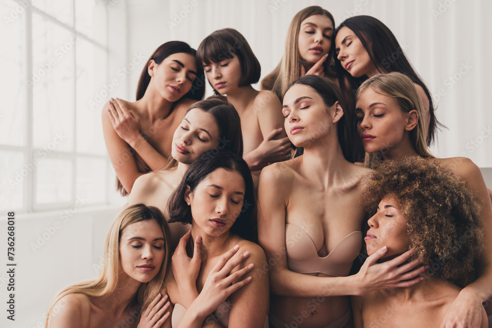 Portrait of charming group women in beige lingerie hugging themselves and posing isolated on white color background Portrait of charming group women in beige lingerie hugging themselves and posing isolated on white color background