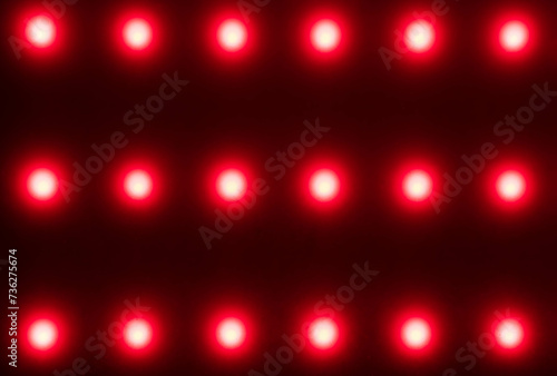Картината върху платно red blurred dots on black background, red light therapy