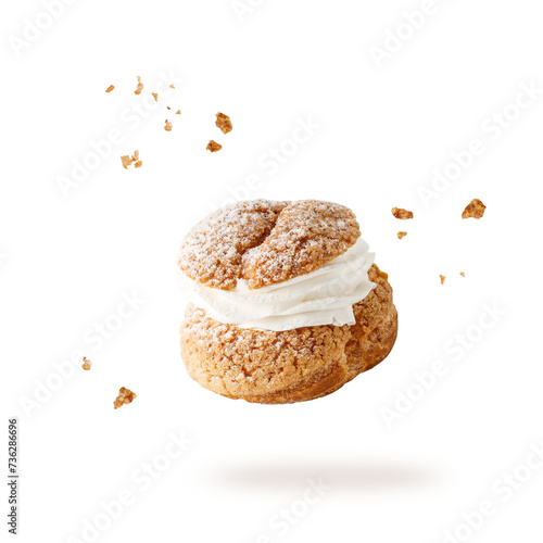 Cream puffs, pastry from choux filled vanila cream covered sugar powder closeup falling flying isolated on white background. Sweet  dessert Choux for coffee break