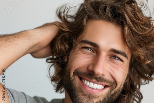 Smiling man proudly displaying his furfur free healthy hair photo