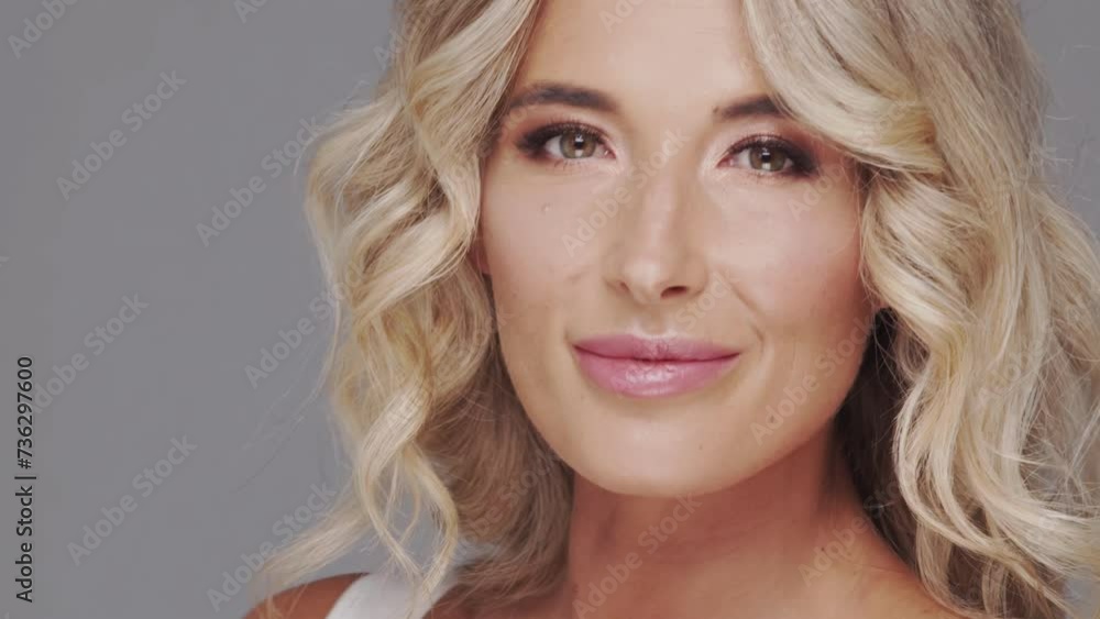 Studio portrait of young and beautiful blond woman over grey background. Skin care and wellness concepts. Studio portrait of young and beautiful blond woman over grey background. Skin care and wellness concepts.