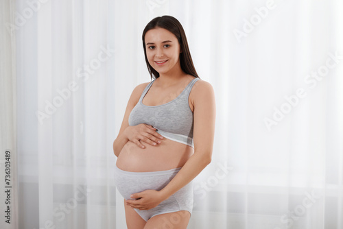 Beautiful pregnant woman in comfortable maternity underwear indoors Free Download Beautiful pregnant woman in comfortable maternity underwear indoors - GFXLoad
