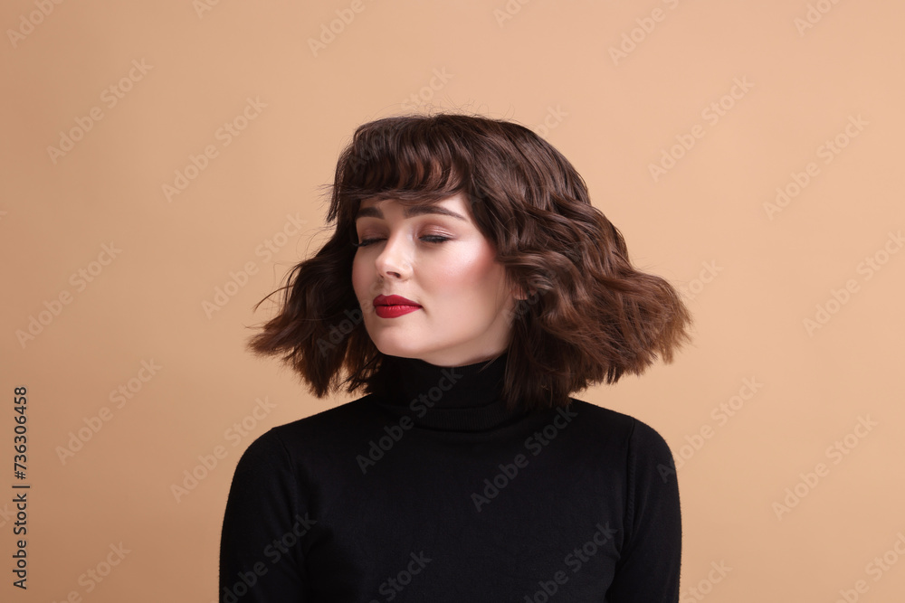 Portrait of beautiful young woman with wavy hairstyle on beige background Portrait of beautiful young woman with wavy hairstyle on beige background