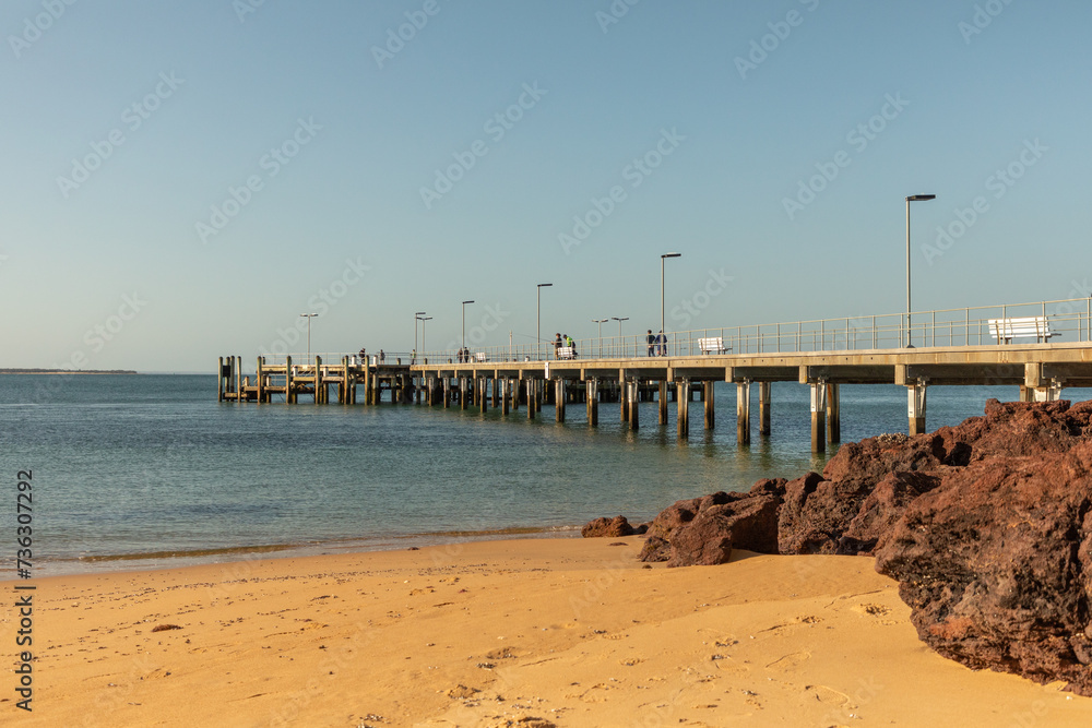 The Cowes jetty, on Phillip Island south of Melbourne, is a popular fishing and tourist spot overlooking the waters of Western Port Bay. - obrazy, fototapety, plakaty 