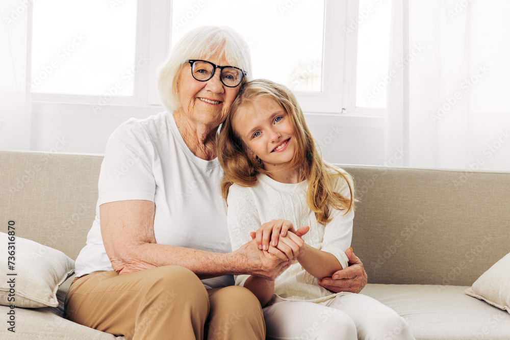 Woman child granddaughter love couch girl old sofa home family grandmother happy Woman child granddaughter love couch girl old sofa home family grandmother happy