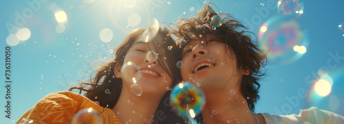 Young couple play together with bubble blower Wonder and Joy concept