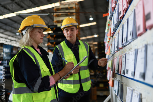 фотографія Blue-collar workers work at the KANBAN 
 delivery board at the warehouse
