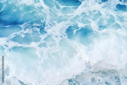 Blue sea water with foam as abstract background. Top view. Copy space