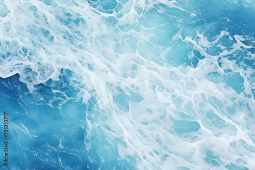 Blue sea water with foam as a background. Close-up. © Ula