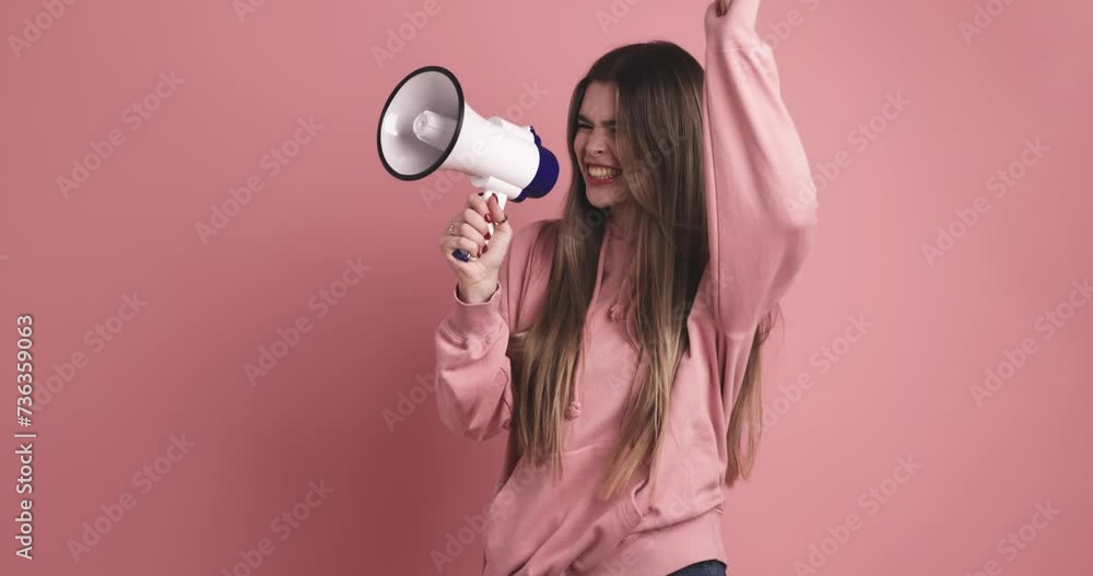 Excited young female standing and announcing into loudspeaker Excited young female standing and announcing into loudspeaker