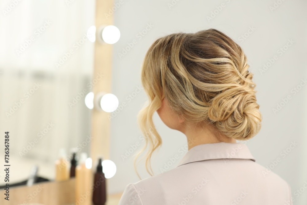 Fototapeta premium Woman with beautiful hair style in salon. Space for text