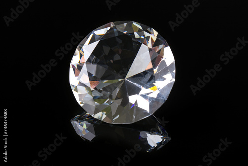Beautiful shiny diamond on black mirror surface  closeup